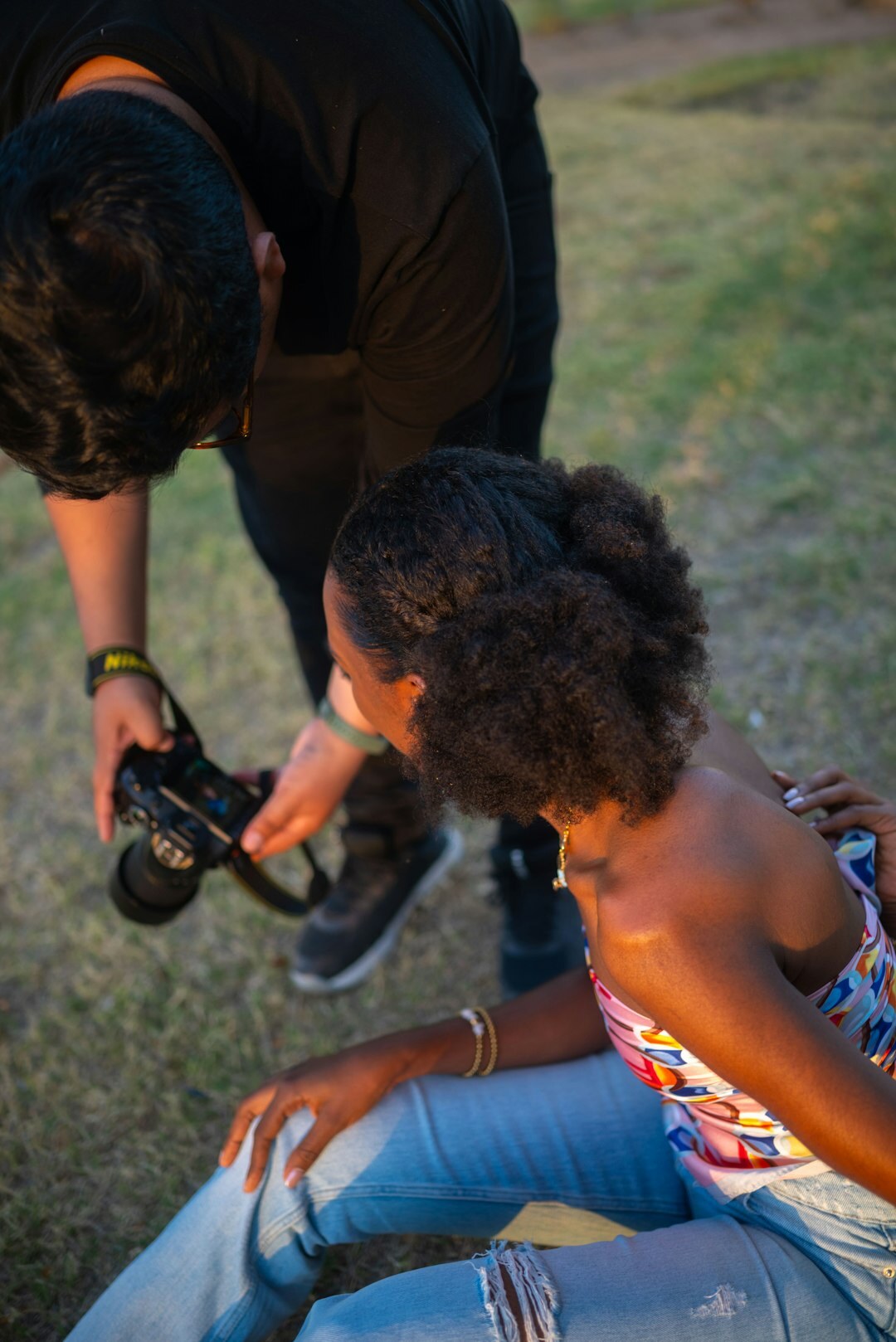 Photographer crouching to take a photo of a family outdoors