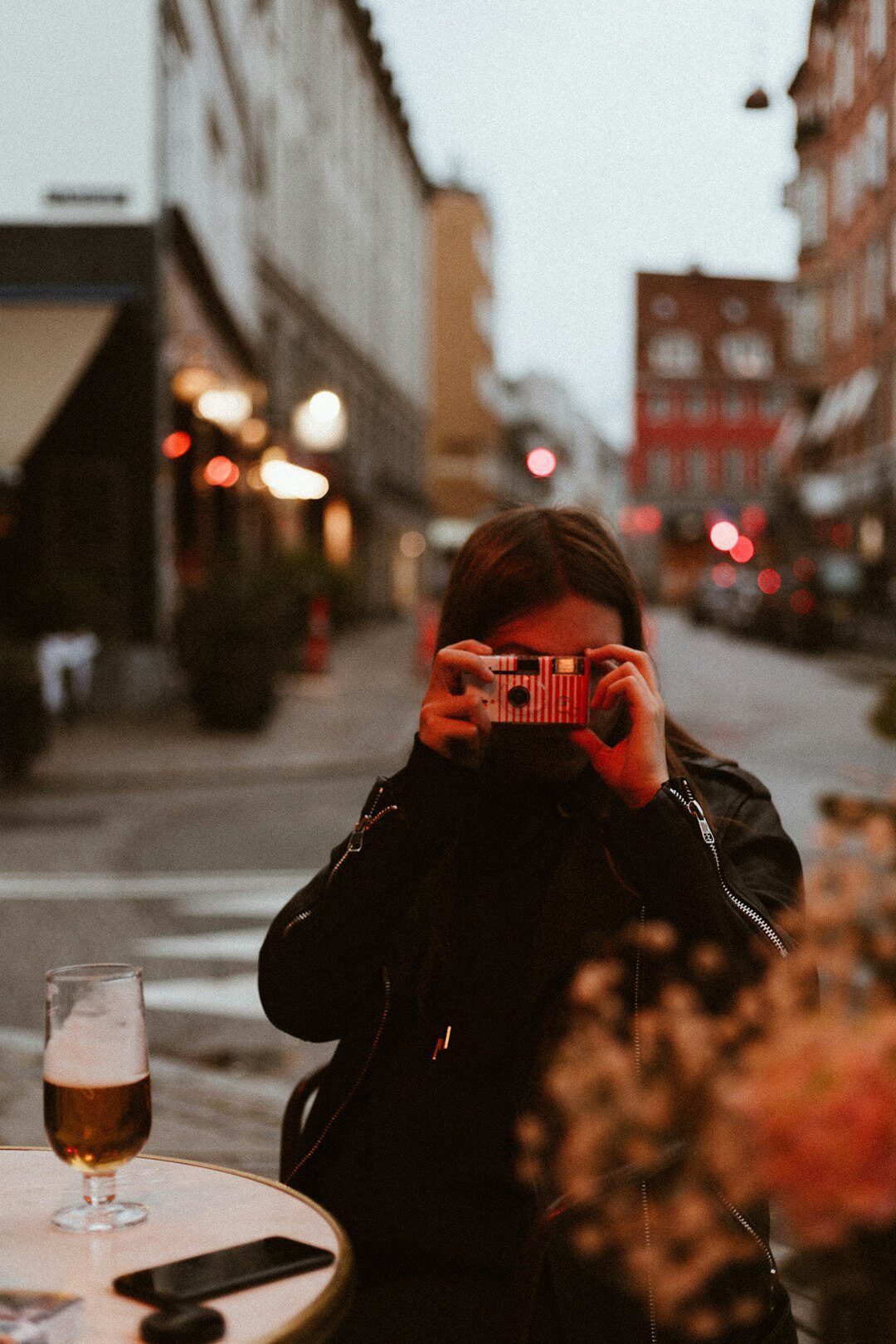 Portrait of a Danish female documentary photographer holding a camera